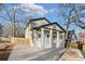 Home featuring a covered front porch and a newly paved driveway, complemented by mature trees at 1986 Memorial Se Dr, Atlanta, GA 30317
