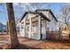 Beautiful exterior showcasing the covered front porch of this newly built home, plus yard with wood fencing at 1986 Memorial Se Dr, Atlanta, GA 30317