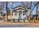 Charming home with a welcoming front porch, white railing, blue front door, and fresh landscaping at 1986 Memorial Se Dr, Atlanta, GA 30317