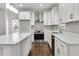 Modern kitchen with stainless steel appliances, quartz countertops, and shaker cabinets at 1986 Memorial Se Dr, Atlanta, GA 30317