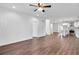 Spacious living room with hardwood floors, leading to a modern kitchen with white cabinets and stainless steel appliances at 1986 Memorial Se Dr, Atlanta, GA 30317