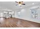 Open-concept living room featuring hardwood floors, a ceiling fan, and natural light from multiple windows at 1986 Memorial Se Dr, Atlanta, GA 30317