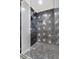 Close-up of shower with unique patterned tile and a glass door at 1986 Memorial Se Dr, Atlanta, GA 30317