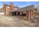Backyard showing concrete, red brick, and green trash bin at 2329 Crestknoll Cir, Decatur, GA 30032