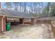 The house's backyard features a covered area, red brick, and brick wall at 2329 Crestknoll Cir, Decatur, GA 30032