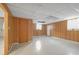 Unfinished basement with paneled walls, concrete floor, and utilities, offering potential for customization at 2329 Crestknoll Cir, Decatur, GA 30032