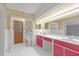 Bathroom features a large mirror, white tile flooring, and red cabinets at 2329 Crestknoll Cir, Decatur, GA 30032