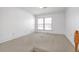 Bright bedroom with natural light from a window and neutral walls complemented by clean, neutral carpet at 2329 Crestknoll Cir, Decatur, GA 30032