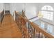 Grand foyer view showcasing hardwood floors, decorative chandelier, and staircase with wrought iron spindles at 2329 Crestknoll Cir, Decatur, GA 30032