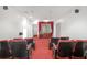 Home theater with multiple rows of seating, red carpet, and white walls creating an immersive viewing experience at 2329 Crestknoll Cir, Decatur, GA 30032
