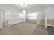Partially renovated living area featuring large windows and decorative molding at 2329 Crestknoll Cir, Decatur, GA 30032