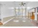 Bright living room features soaring ceilings, large windows and a traditional brick fireplace at 2329 Crestknoll Cir, Decatur, GA 30032