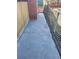 Narrow concrete pathway along the side of the house with chain-link fence at 2329 Crestknoll Cir, Decatur, GA 30032