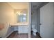Modest bathroom featuring a vanity, mirror, toilet, and worn wood-look floors at 3500 Quail Hollow Trl, Snellville, GA 30039