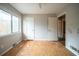 Empty bedroom featuring two closets, weathered hardwood, and natural light at 3500 Quail Hollow Trl, Snellville, GA 30039