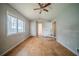 Bedroom with plywood flooring, a ceiling fan, and a large window at 3500 Quail Hollow Trl, Snellville, GA 30039
