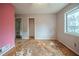Spacious bedroom with worn floors, natural light, and closet access at 3500 Quail Hollow Trl, Snellville, GA 30039