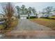 Split-level home with a two-car garage and a long driveway on a sloped lot at 3500 Quail Hollow Trl, Snellville, GA 30039