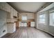 Kitchen featuring granite countertops, laminate flooring, and white cabinetry at 3500 Quail Hollow Trl, Snellville, GA 30039