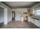 Kitchen with granite countertops, white cabinets, and laminate flooring at 3500 Quail Hollow Trl, Snellville, GA 30039