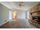 Open living room layout with laminate flooring and a stone fireplace at 3500 Quail Hollow Trl, Snellville, GA 30039