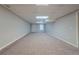 A finished basement with neutral carpet, light gray walls, and a drop ceiling at 4570 Thicket Trl, Snellville, GA 30039