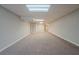 A finished basement with neutral carpet, light gray walls, and a drop ceiling at 4570 Thicket Trl, Snellville, GA 30039