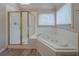 Bathroom featuring a shower, tub and tiled walls at 4570 Thicket Trl, Snellville, GA 30039