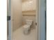 The powder room features a toilet, cabinet and shelf at 4570 Thicket Trl, Snellville, GA 30039