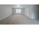 A large bedroom offers a large window and neutral colored carpet at 4570 Thicket Trl, Snellville, GA 30039