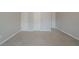 A large bedroom offers neutral carpet, light gray walls, and multiple closets at 4570 Thicket Trl, Snellville, GA 30039