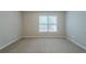 This bedroom features a bright window, neutral carpet, and light gray walls at 4570 Thicket Trl, Snellville, GA 30039
