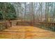 Wooden deck with railing overlooking a wooded backyard perfect for relaxing and outdoor activities at 4570 Thicket Trl, Snellville, GA 30039