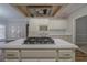 Kitchen island with a cooktop and white cabinetry, offering a great view of the kitchen at 4570 Thicket Trl, Snellville, GA 30039