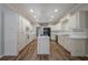 Spacious kitchen featuring white cabinets, stainless steel appliances, and a center island at 4570 Thicket Trl, Snellville, GA 30039