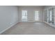 A living room offering outdoor access, natural light and neutral carpet at 4570 Thicket Trl, Snellville, GA 30039