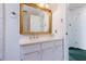 Bathroom features a white vanity with a marble countertop, a framed mirror, and a towel rack at 2 Westchester Sq, Decatur, GA 30030