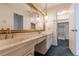 Well-lit bathroom with dual sinks, mirrors, and access to walk-in closet at 2 Westchester Sq, Decatur, GA 30030