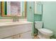 Bathroom with a vanity, toilet, and sink with green wall color at 2 Westchester Sq, Decatur, GA 30030