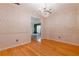 Elegant dining room featuring a chandelier and decorative wallpaper and wood flooring, bathed in natural light at 2 Westchester Sq, Decatur, GA 30030