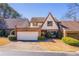 Charming home featuring a brick garage, gabled roof, and manicured landscaping at 2 Westchester Sq, Decatur, GA 30030