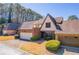 Charming home with attached garages and manicured landscaping on a sunny day at 2 Westchester Sq, Decatur, GA 30030