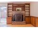 Living room fireplace featuring brick surround, decorative mantel, and built-in shelving at 2 Westchester Sq, Decatur, GA 30030