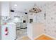 Retro kitchen with white cabinets, appliances, and vintage wallpaper at 2 Westchester Sq, Decatur, GA 30030