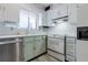 Traditional kitchen with white cabinets, tile flooring, and stainless steel dishwasher at 2 Westchester Sq, Decatur, GA 30030