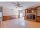 Inviting living room with hardwood floors, a brick fireplace, custom shelving, and a sliding glass door at 2 Westchester Sq, Decatur, GA 30030