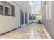 Tiled patio with double doors leading to the home's interior, an a/c unit and a brick wall at 2 Westchester Sq, Decatur, GA 30030