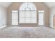 Spacious living room with vaulted ceiling and natural light from large windows at 717 Southland Pass, Stone Mountain, GA 30087