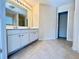 Bright bathroom featuring a double sink vanity and large mirror at 1399 Dukes Creek Nw Dr, Kennesaw, GA 30152