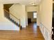 Inviting entryway with wood floors and staircase leading to the upper level at 1399 Dukes Creek Nw Dr, Kennesaw, GA 30152